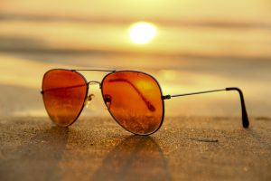 sunglasses on beach at sunset